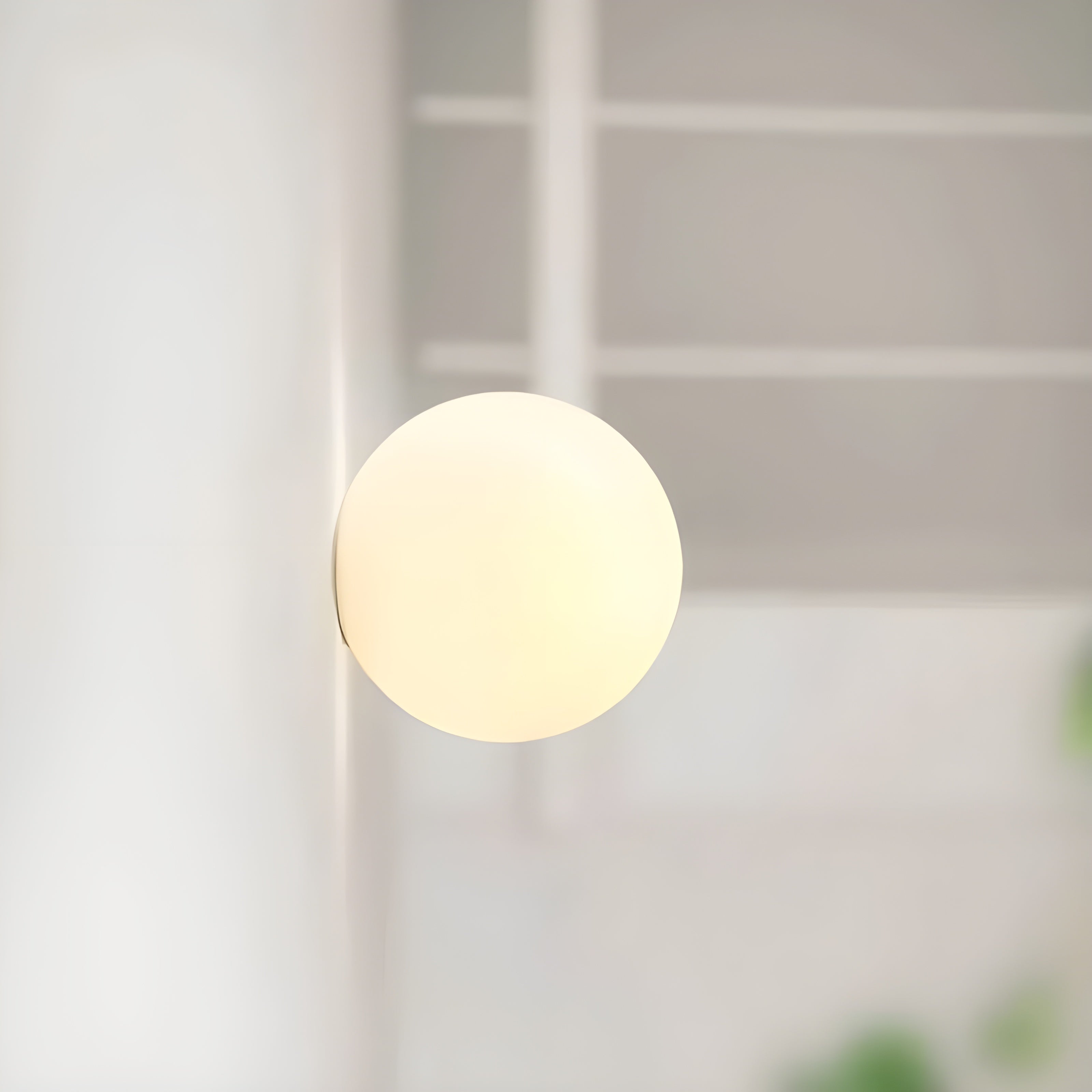 Modern Wall Lamp with Round Frosted Glass Shade and Elegant Base